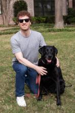 LSJ Academic Adviser Jonathan Fincher on the left with his black lab dog named Soda