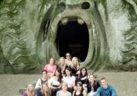 Former LSJ Rome students sitting in front of a troll statue