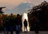 Student stands in front of a fountain.