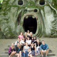 Former LSJ Rome students sitting in front of a troll statue